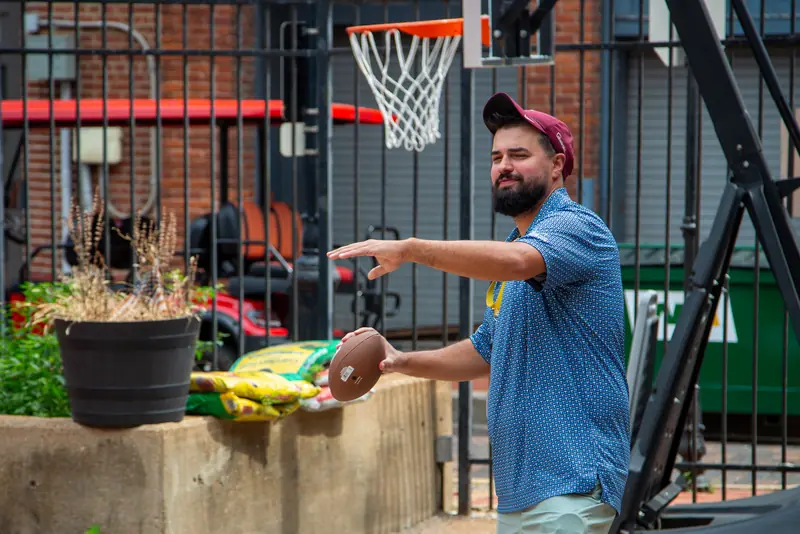 An Abstrakt team member throwing a football at the Touchdown team event in the campus courtyard