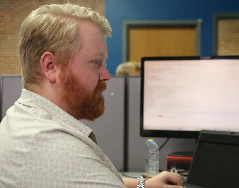 An Abstrakt team member working at his computer in the St. Louis office
