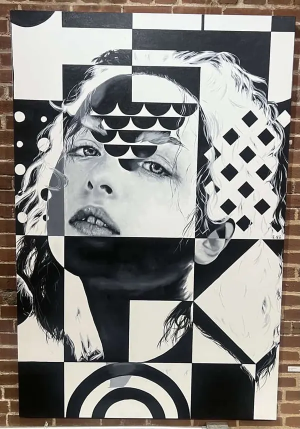 Black and white painting of a woman's face broken up by geometric patterns.