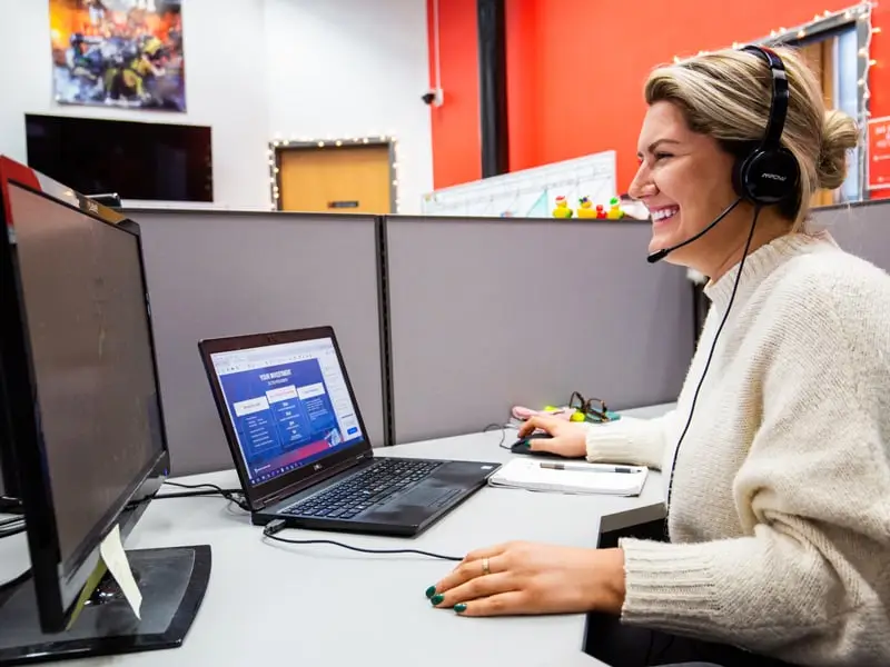 Natalie Archer on a call in a headset