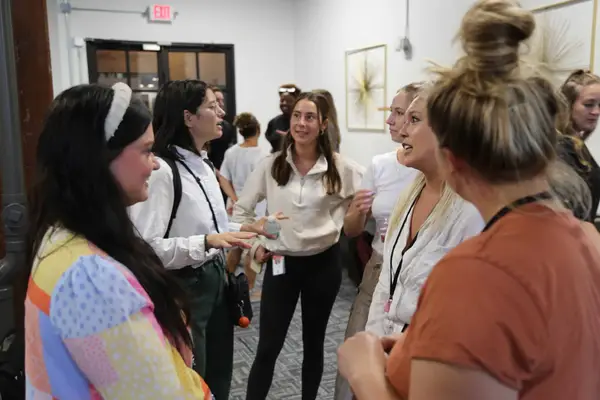 Team members talking at the Women's ERG launch event