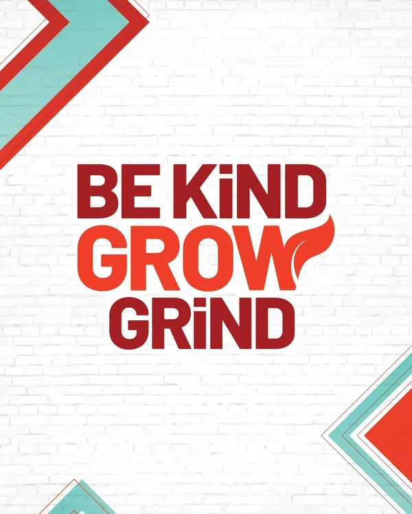 Wall art panel with our theme in large red letters: Be Kind, Grow, Grind, with a flame on the word Grow on a white brick background.