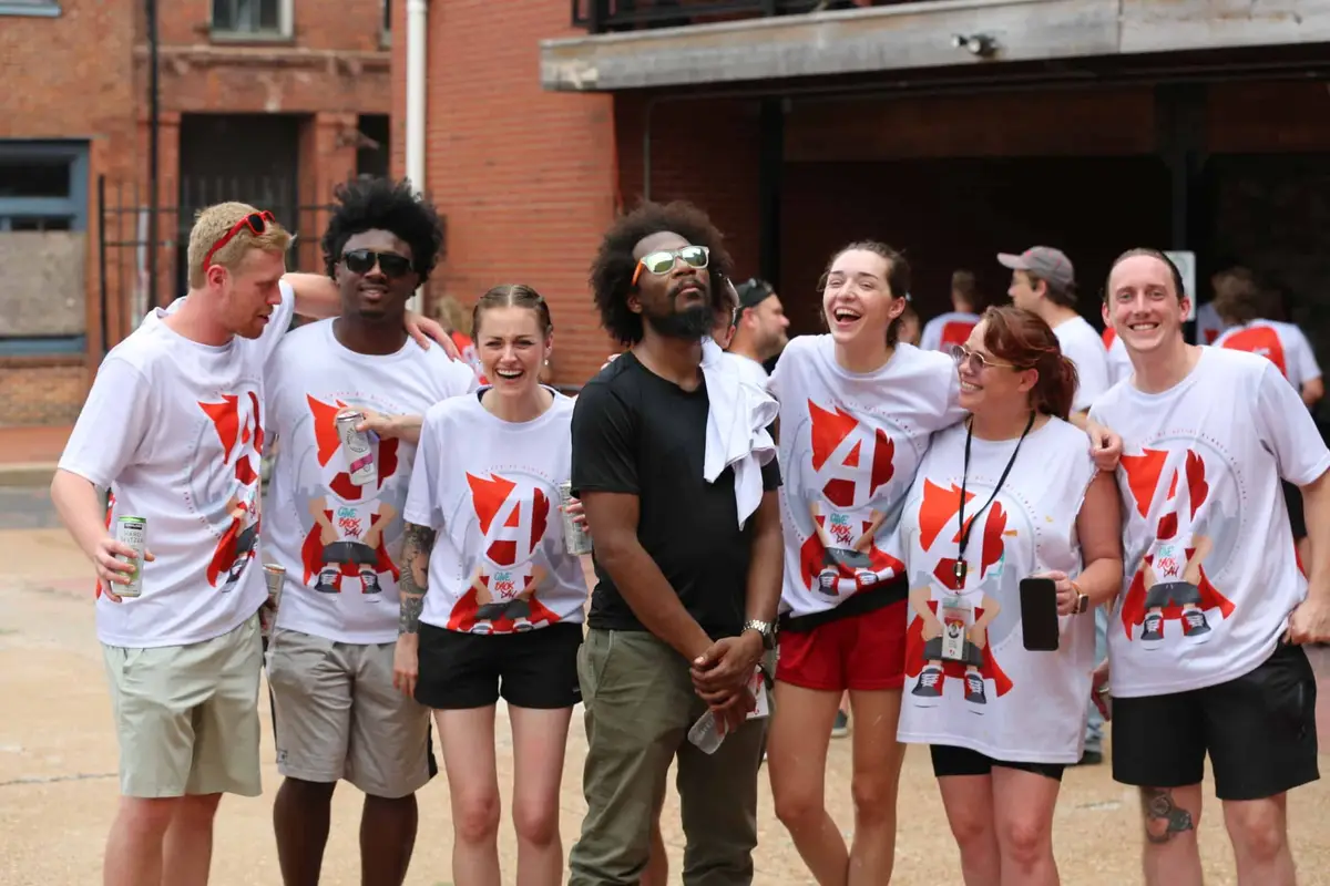 A Give Back Day crew laughing together outside, 2023