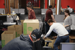 Team members moving boxes