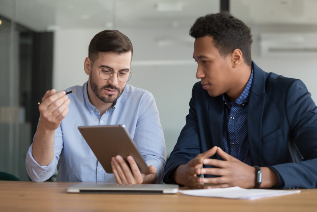 Diverse businessmen working on startup project using electronic tablet application