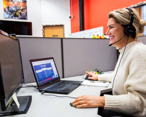 Natalie Archer Sales Rep With Headset Talking to a Potential Client