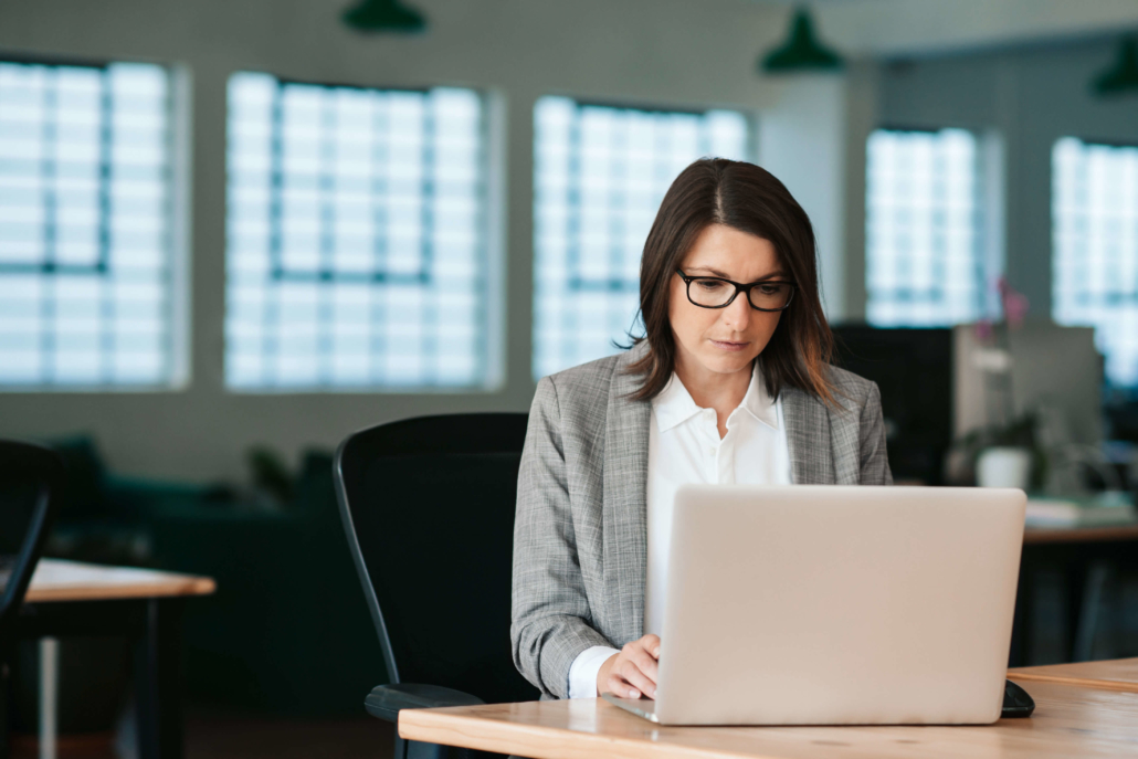 businesswoman on a laptop deep in thought