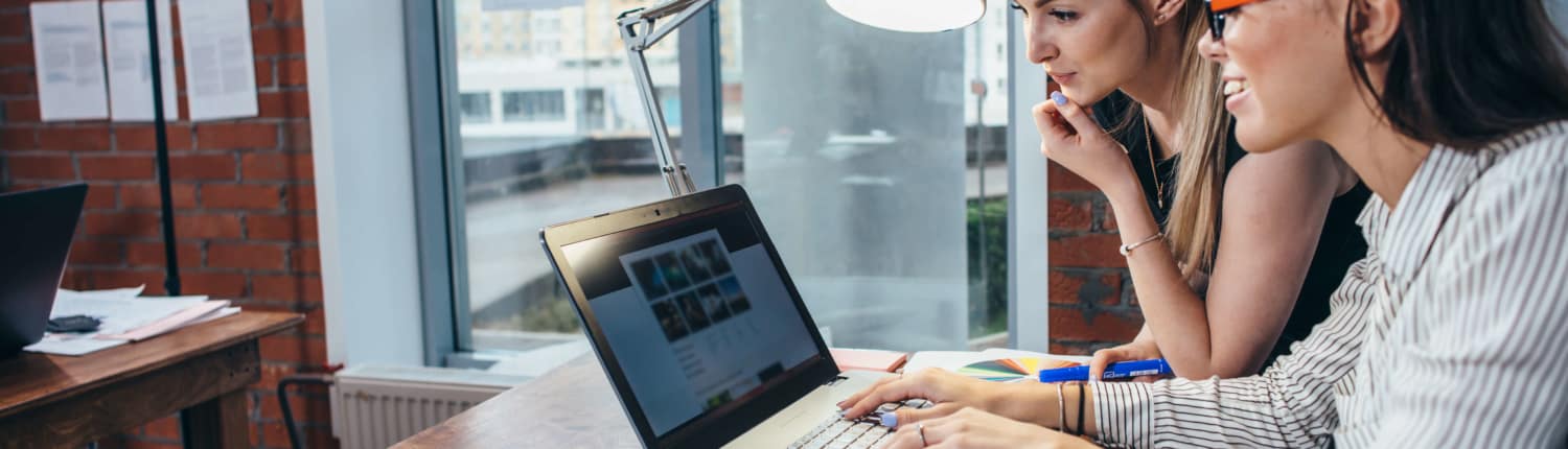 May 8 - effective B2B website design two women reviewing the principles of effective B2B website design