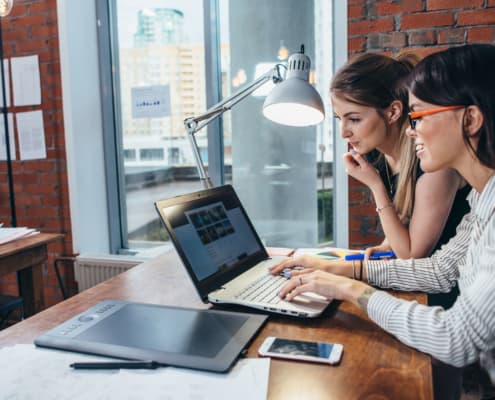 two women reviewing the principles of effective B2B website design