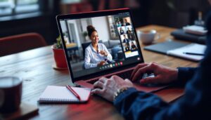 A photograph of a professional setting where a remote appointment setter is engaged in a video call with a client