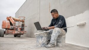 Commercial painting contractor walking a building exterior with a property manager during a fall walkthrough