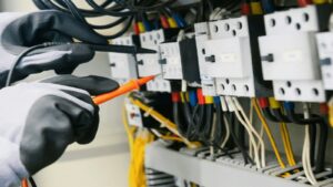 Electrician testing wiring in an electrical panel