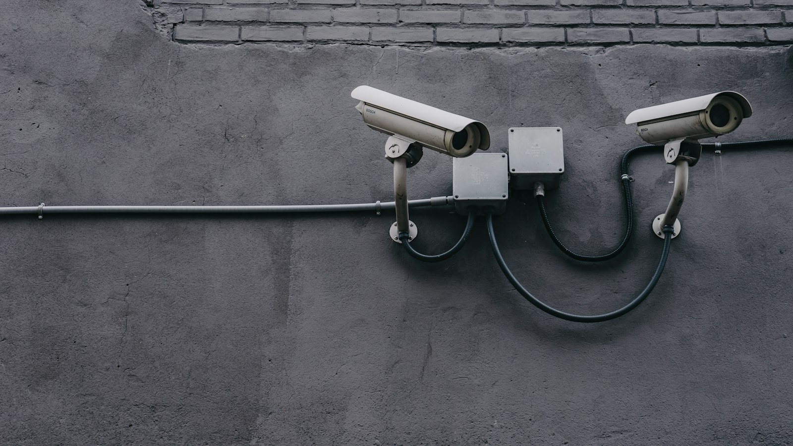 Two security cameras mounted on a building wall